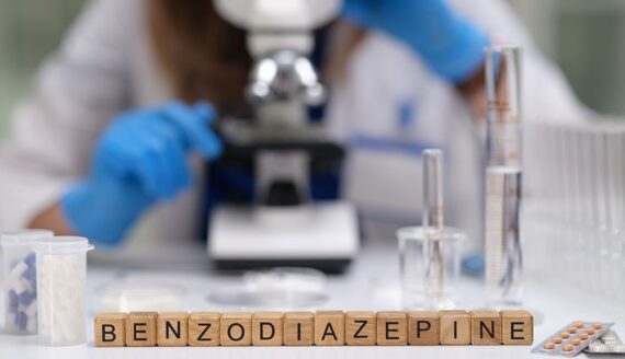 Benzodiazepines written on wooden blocks on research lab desk
