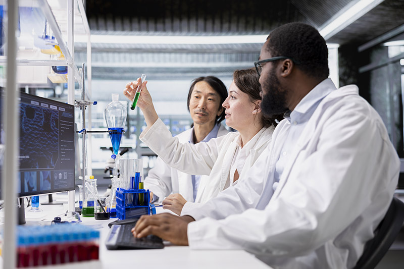 Group of lab scientists analyzing test results from their purpose built QC panel